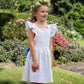 Ruffle cross-strap flower girl dress in ivory and blue by Amelia Brennan Weddings